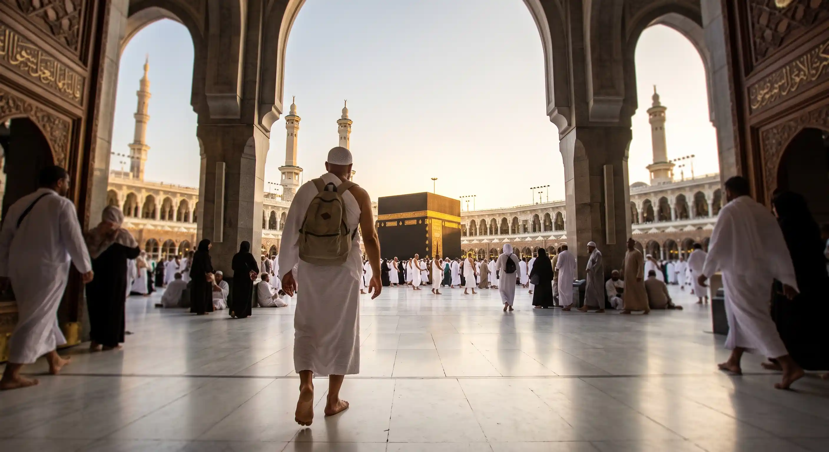 Pilgrim entering Masjid al-Haram in Makkah with the Kaaba visible ahead